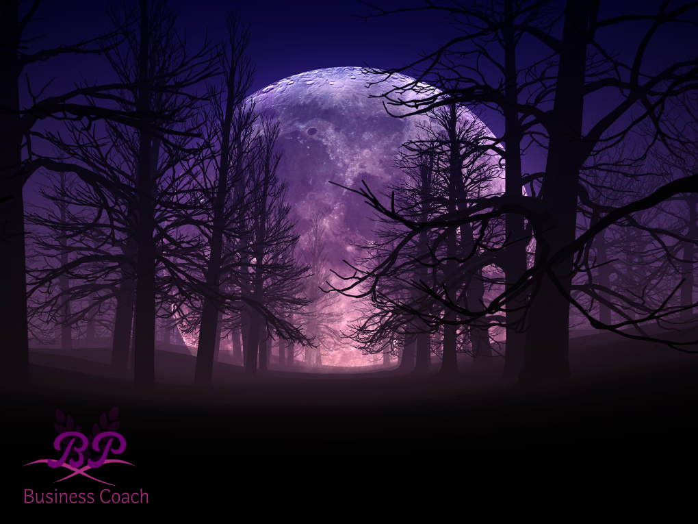 An image of a huge moon at night in the dark forest
